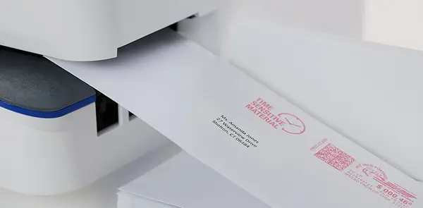 piece of mail going through the SendPro C Auto